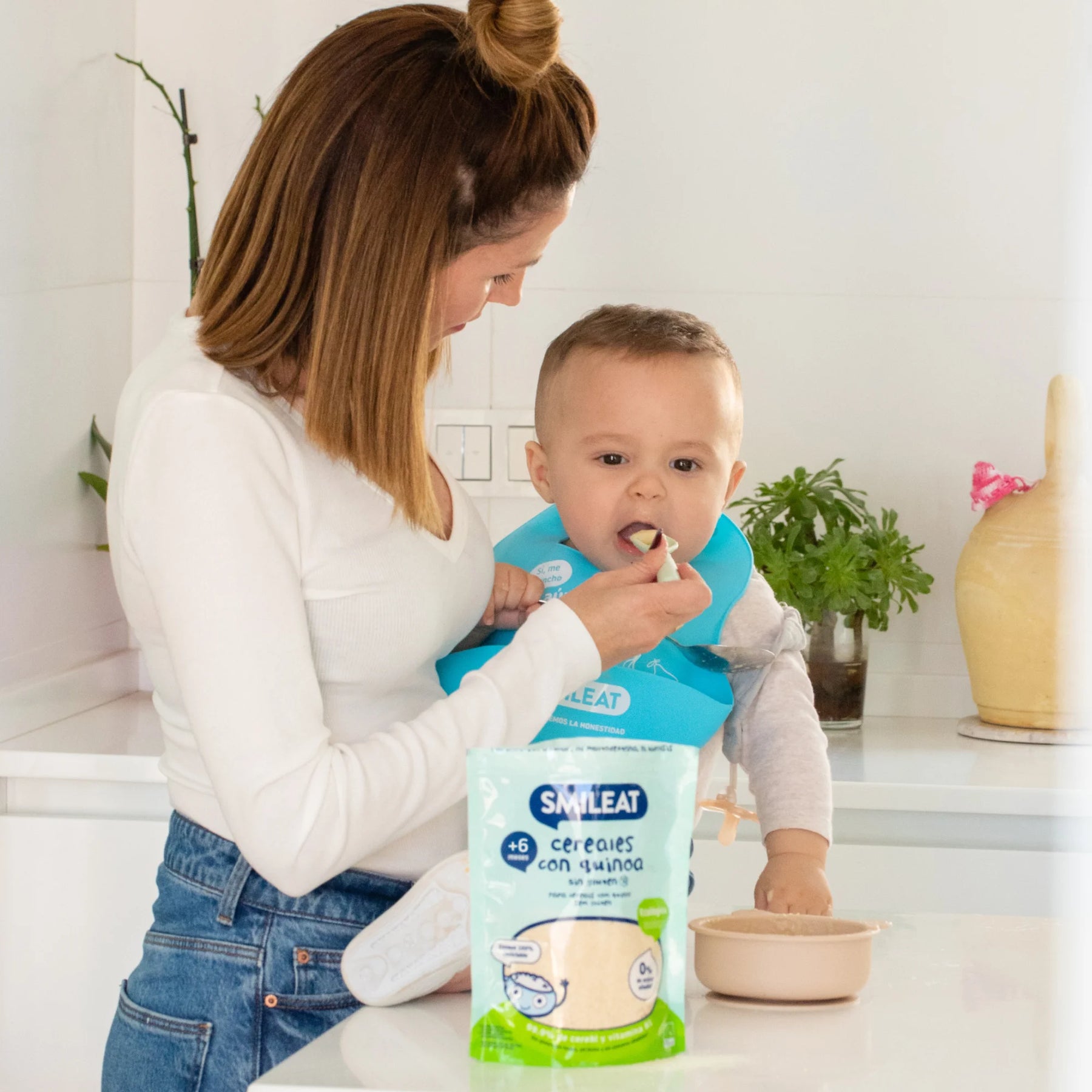 baby eating baby cereal porridge with quinoa smileat