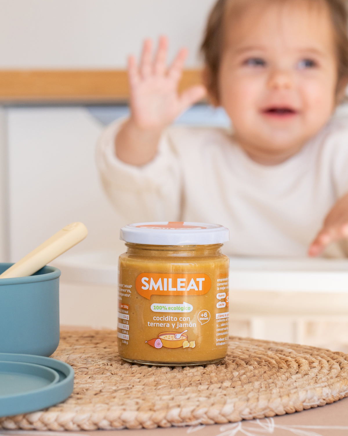 Bebé comiendo tarrito ecológico Smileat de cocidito con ternera y jamón, comida infantil para alimentación complementaria desde 6 meses
