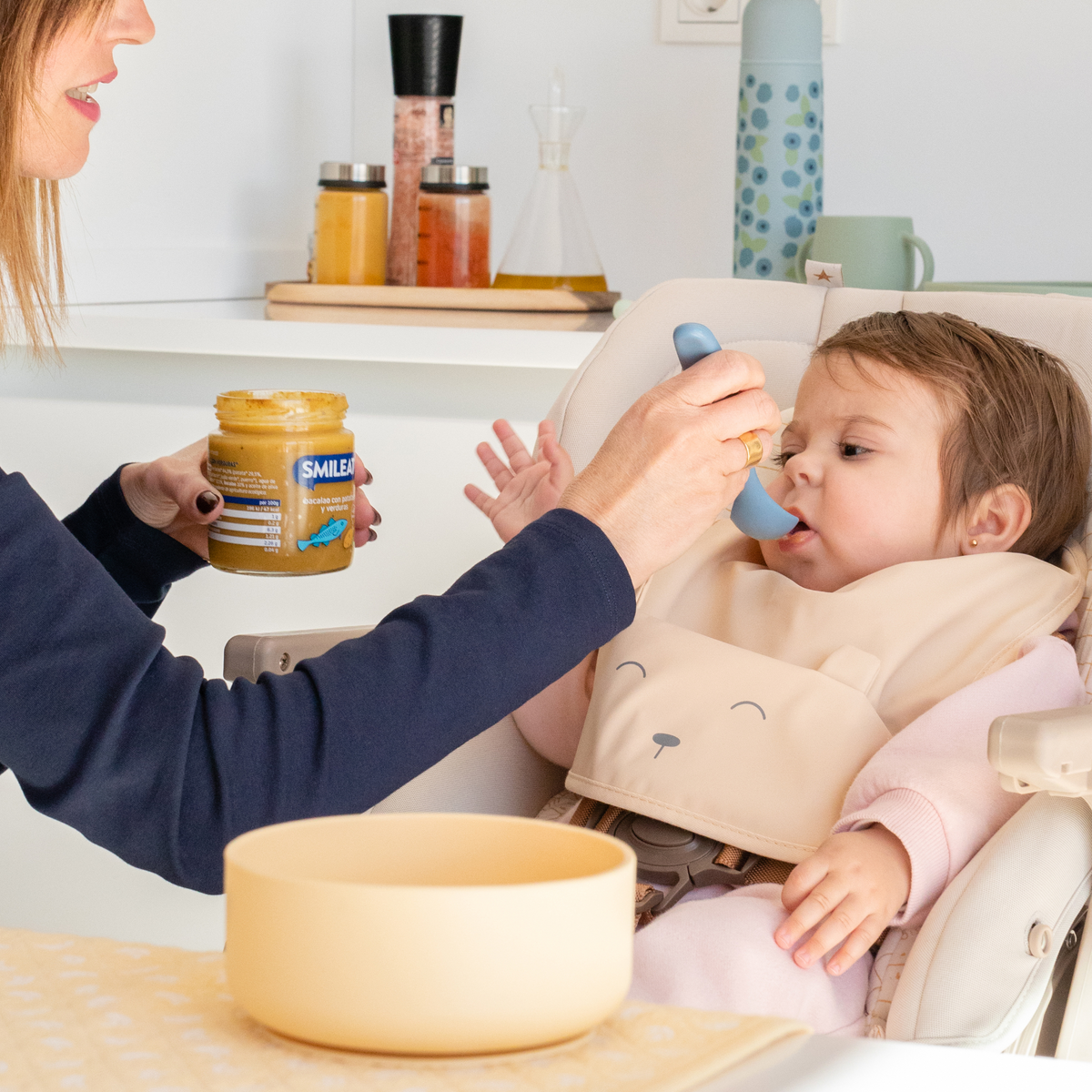 baby eating a small jar of cod with vegetables