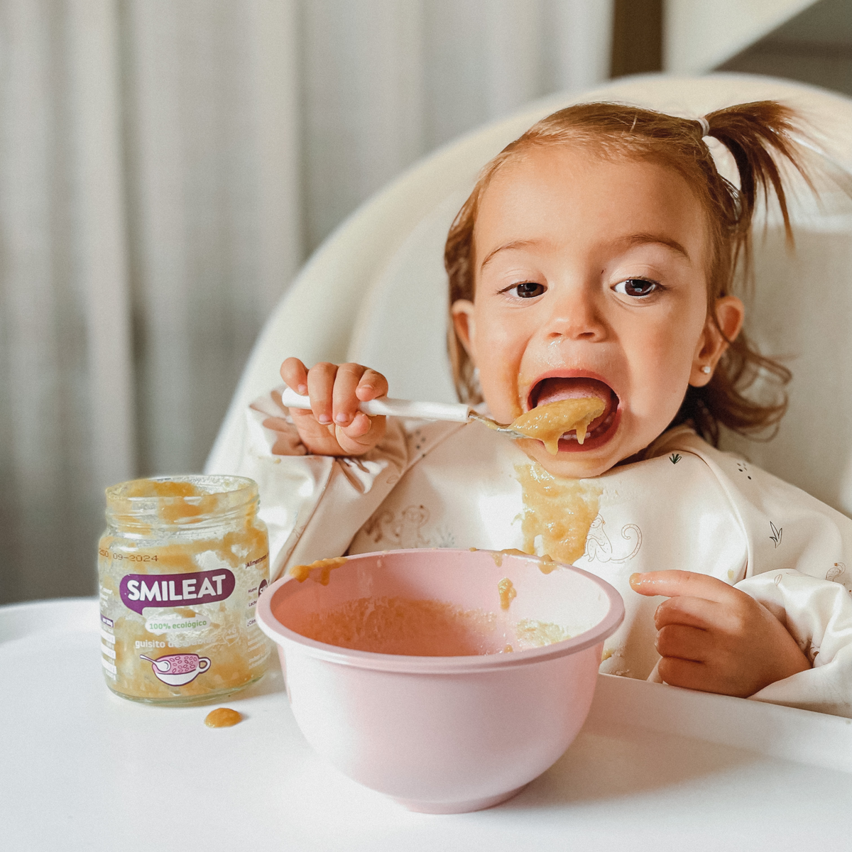 baby eating a jar of bean casserole