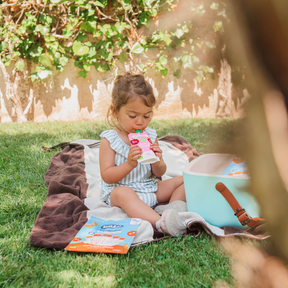 baby eating a yogurt and raspberry pouch