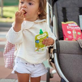 baby eating a pouch of avocado and blueberries