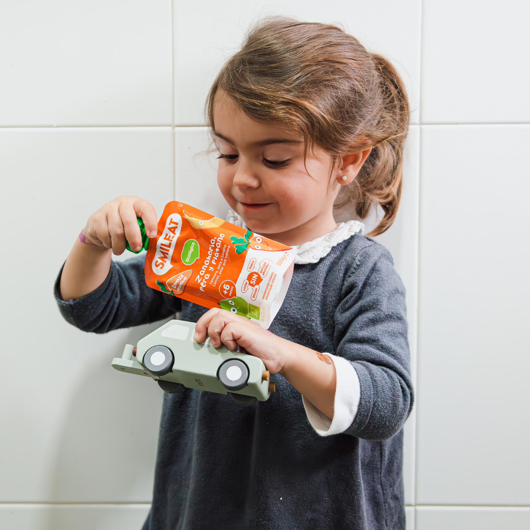 baby eating a carrot, pear and banana pouch