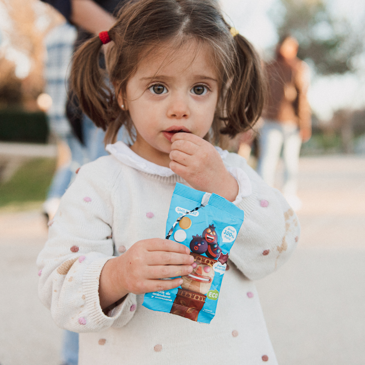 child eating a blueberry and apple snack