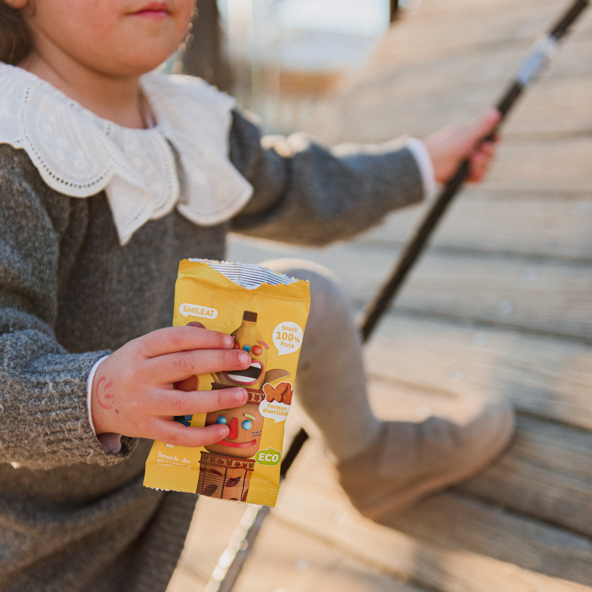 child eating the banana and apple snack