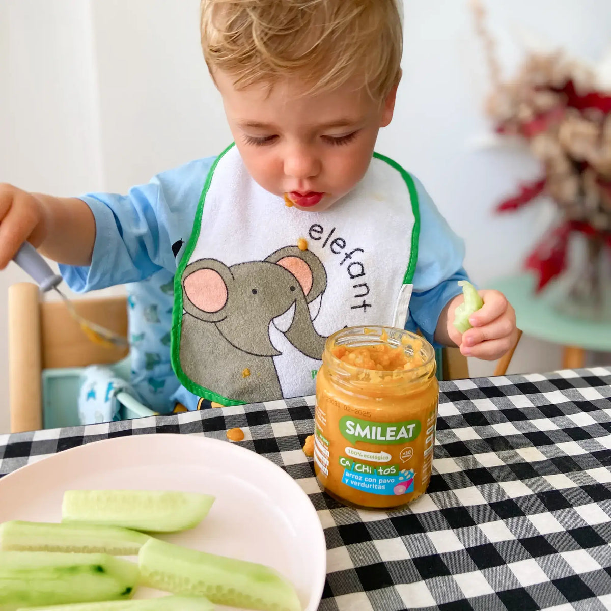 Child eating jar, rice, turkey and vegetables